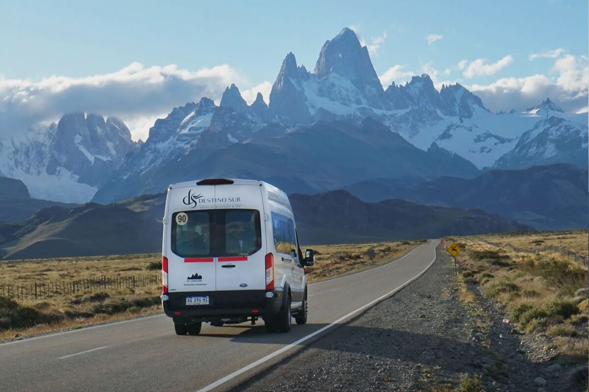 The hotel’s white minibus on the road, with the Fitz Roy massif in the background