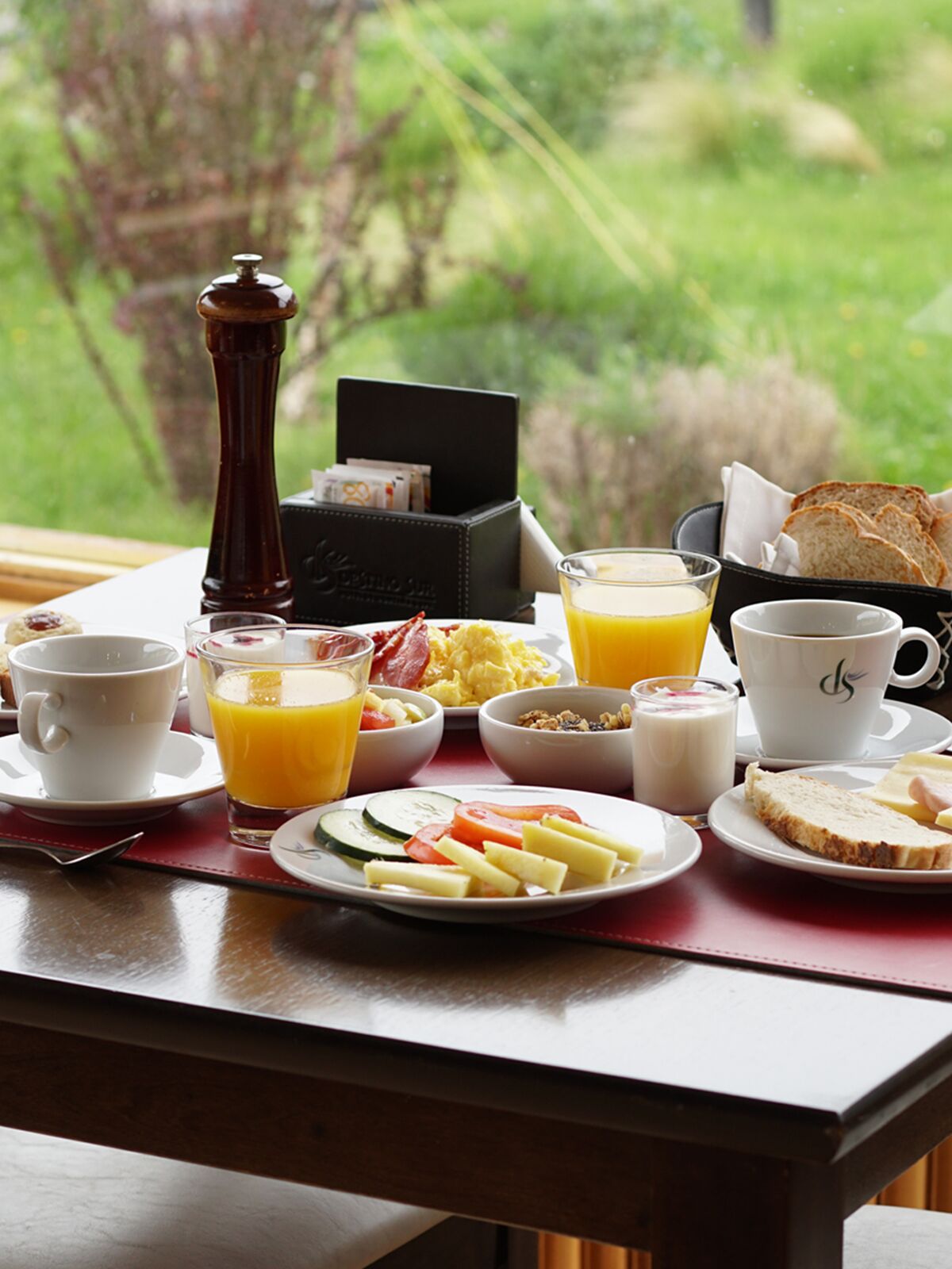 Breakfast served on a table by the window, overlooking the garden