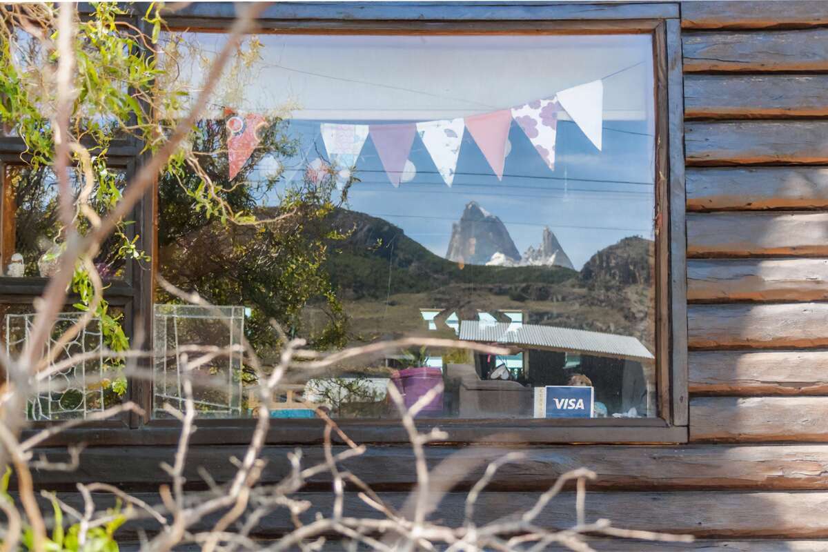 Mount Fitz Roy reflected in a cabin window