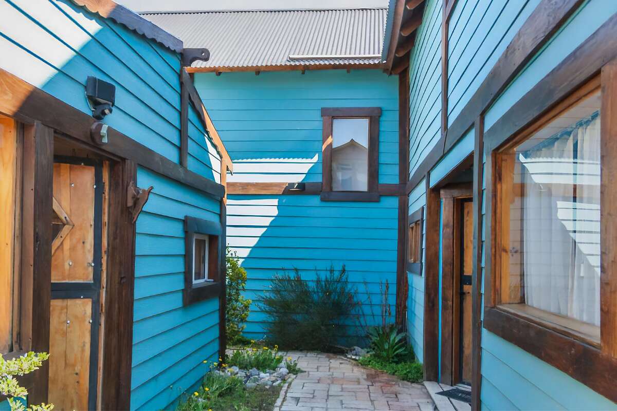 Brick walkway between the light-blue cabins