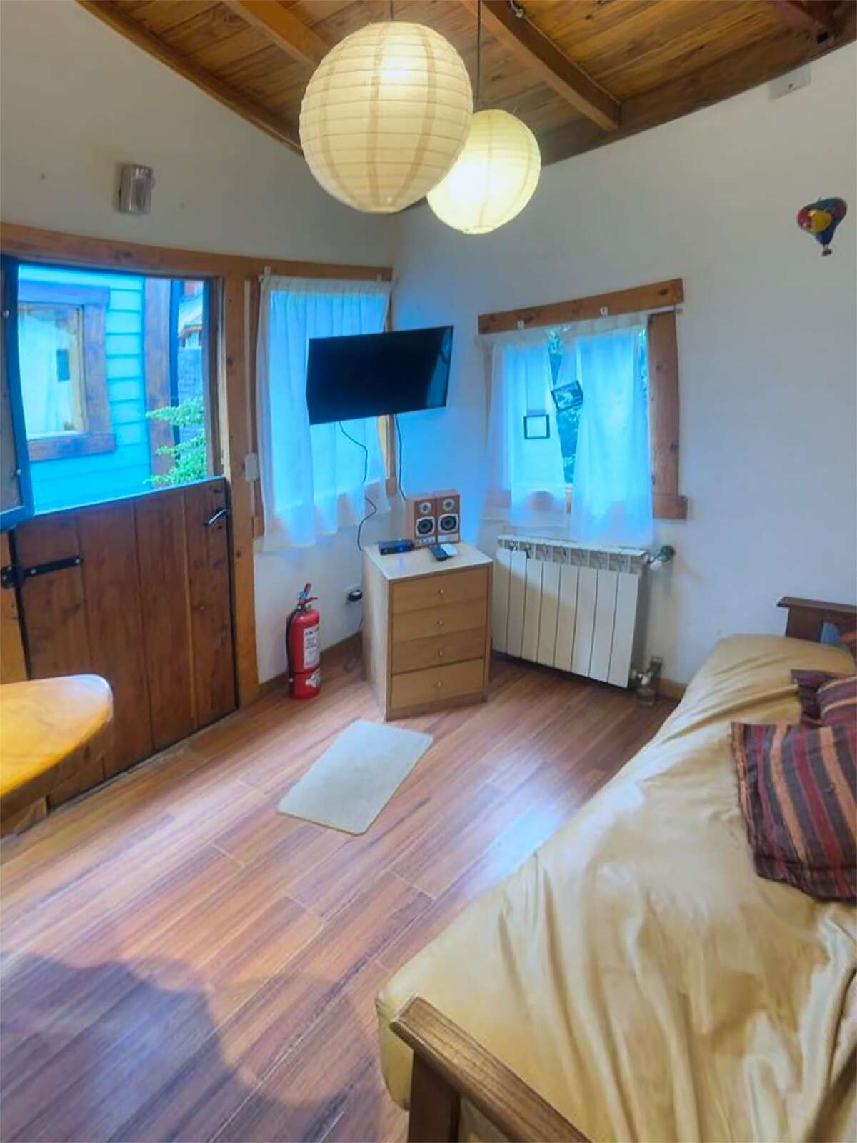 Living room with TV, sofa, radiator and front door