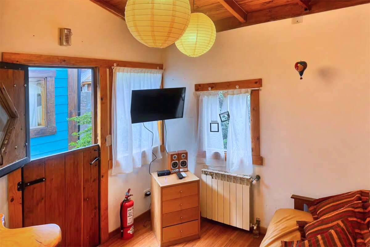 Living room with TV, paper lamps and curtained windows