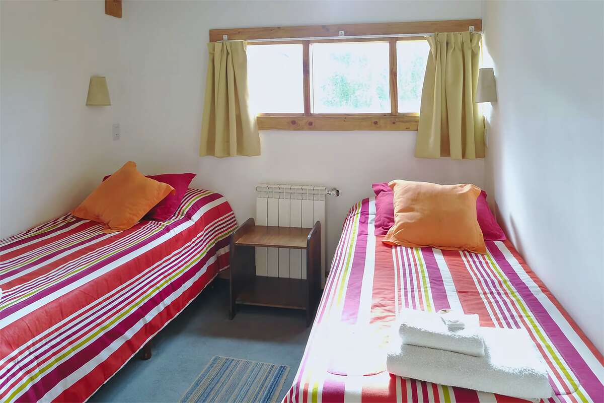 Bedroom with two single beds and a window