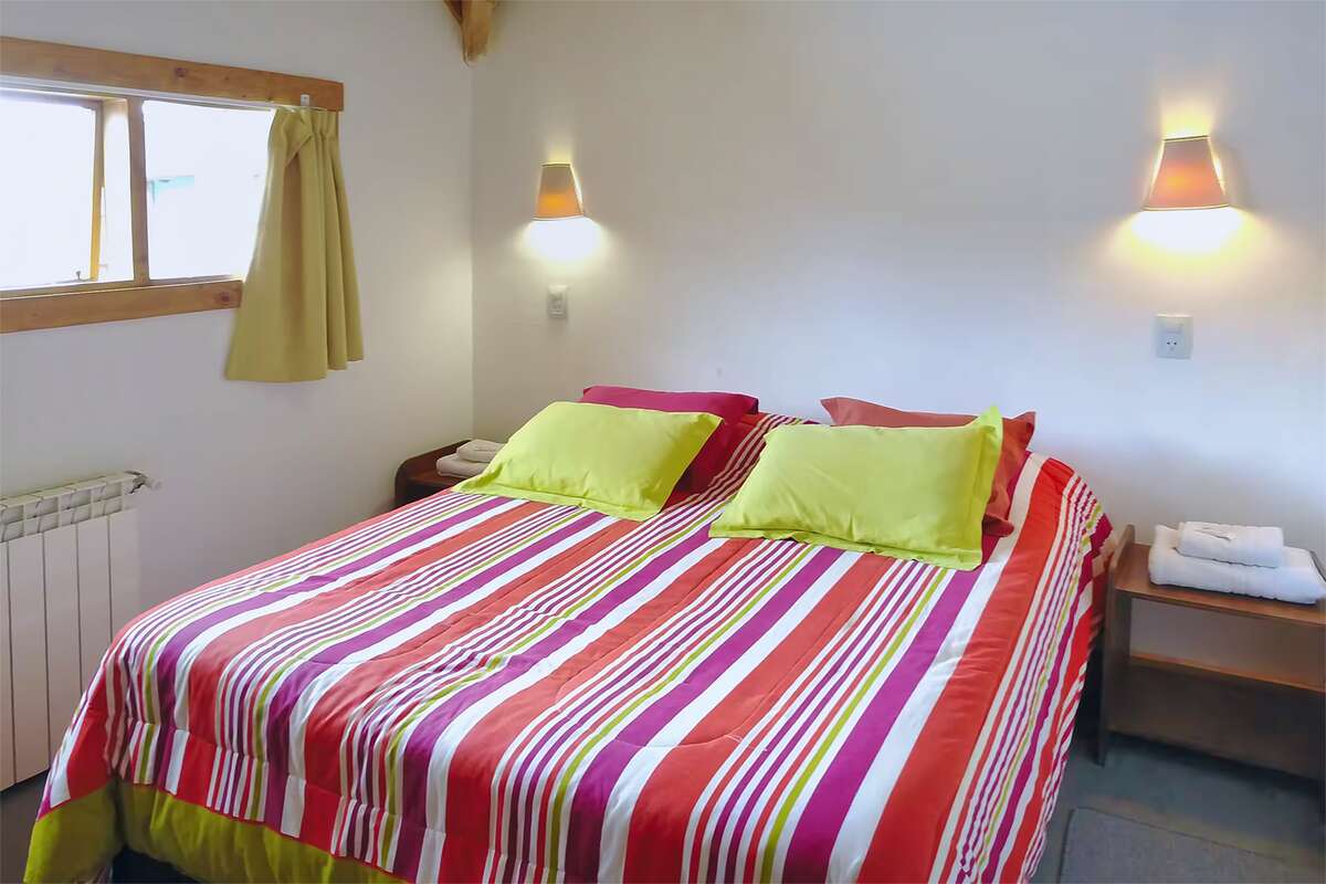 Double bed with wall lamps on each side