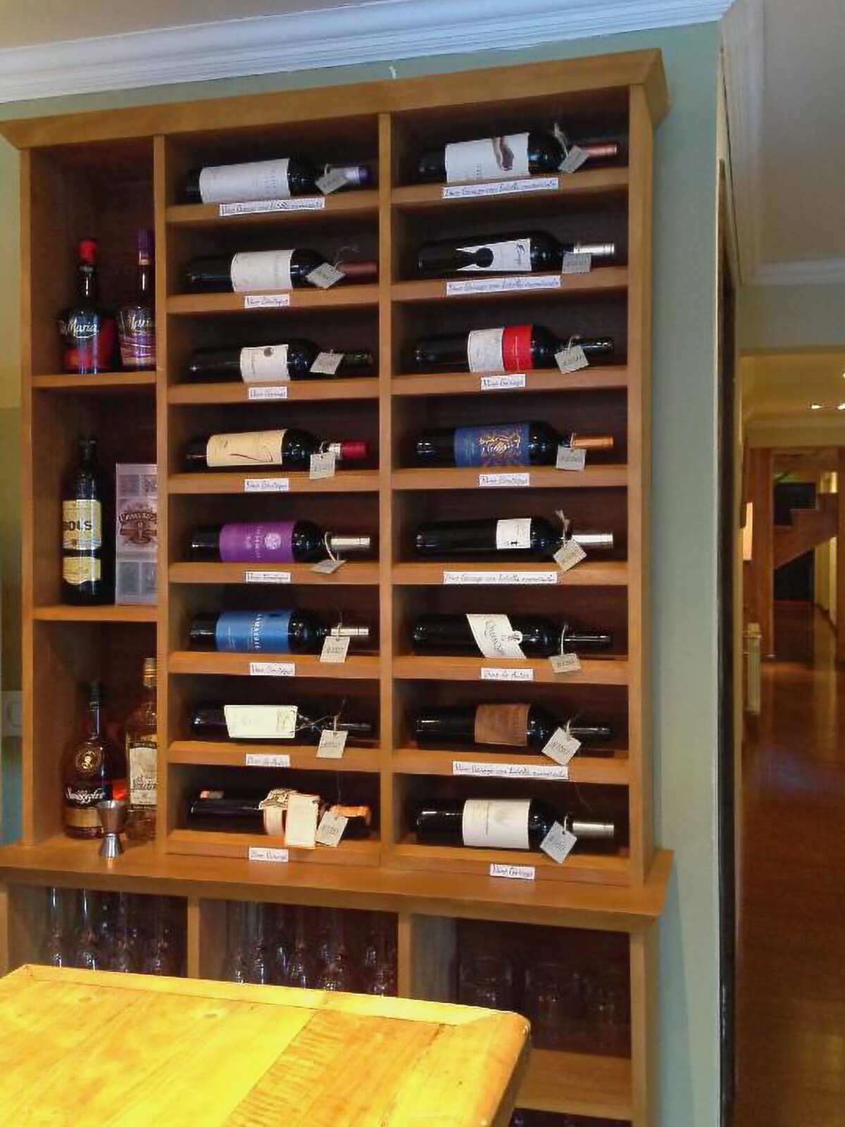 Wooden wine rack with labeled bottles