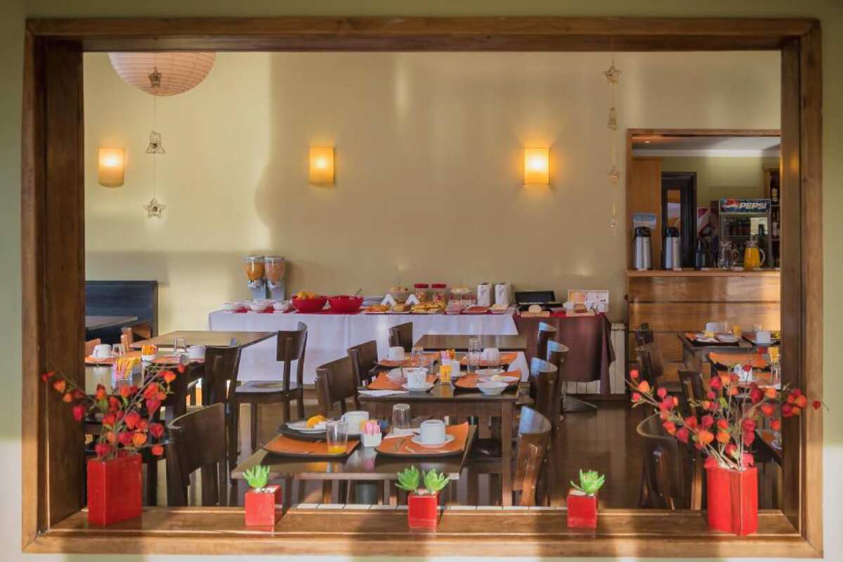 Breakfast room with set tables, seen through an interior window