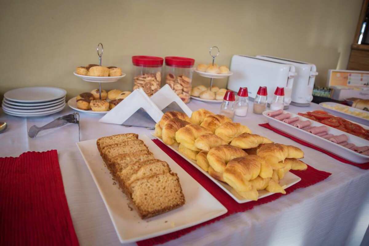 Croissants, sponge cake, bread and pastries on the breakfast table