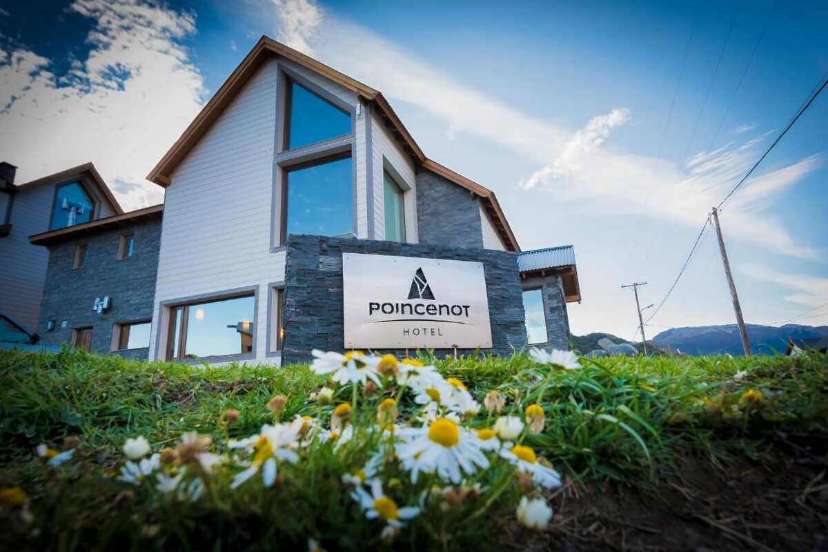 Front of the hotel with the Poincenot sign and chamomile flowers in the foreground